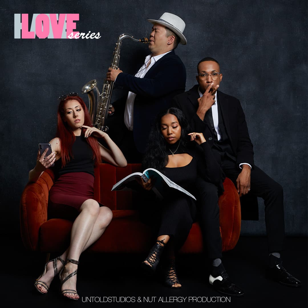 The cast of Love Series, the team’s first project, on a red sofa